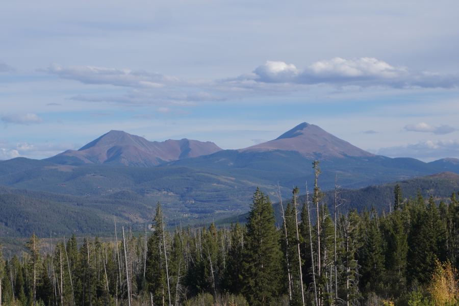 Twin peaks rising above a forested valley